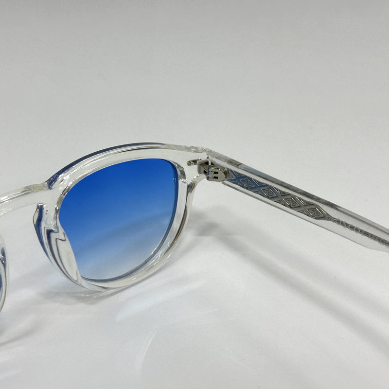 Sunglasses with blue gradient lenses on a light gray background